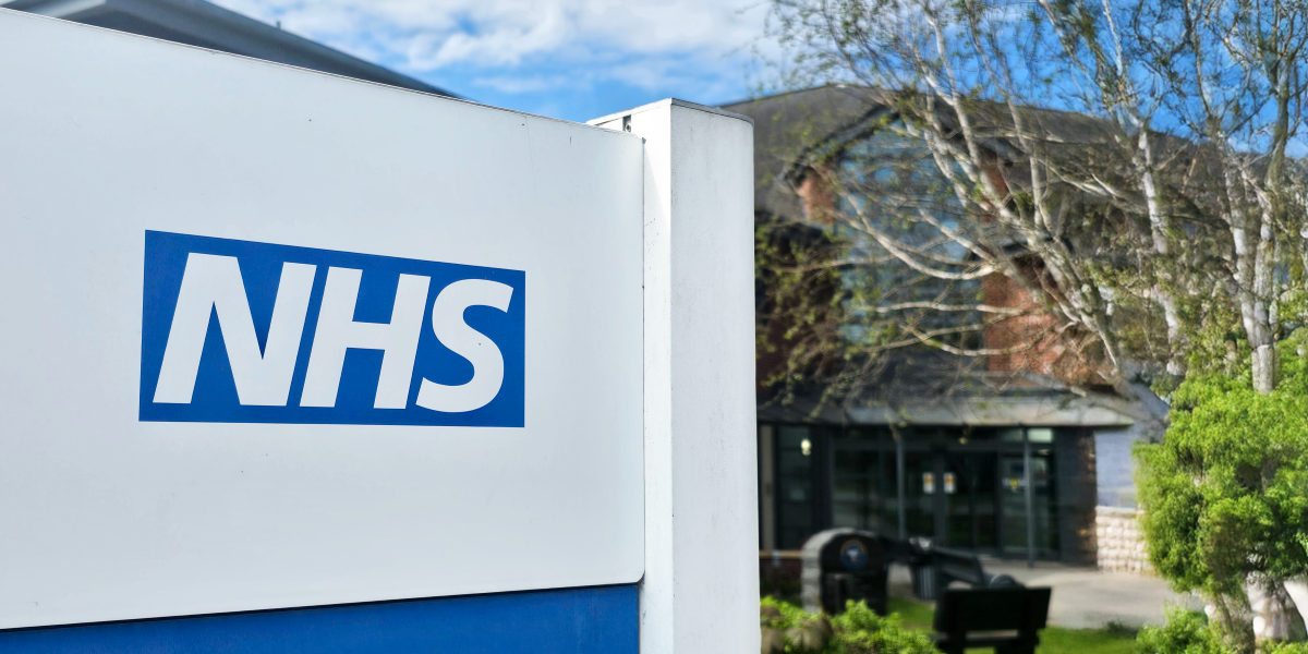Image of NHS logo on sign outside of mental health hospital